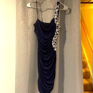 navy blue knee length dress with jewels on the side and strap